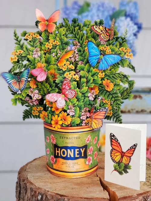 Butterflies & Buttercups Pop-Up - assembled bouquet with greeting card on tree stump